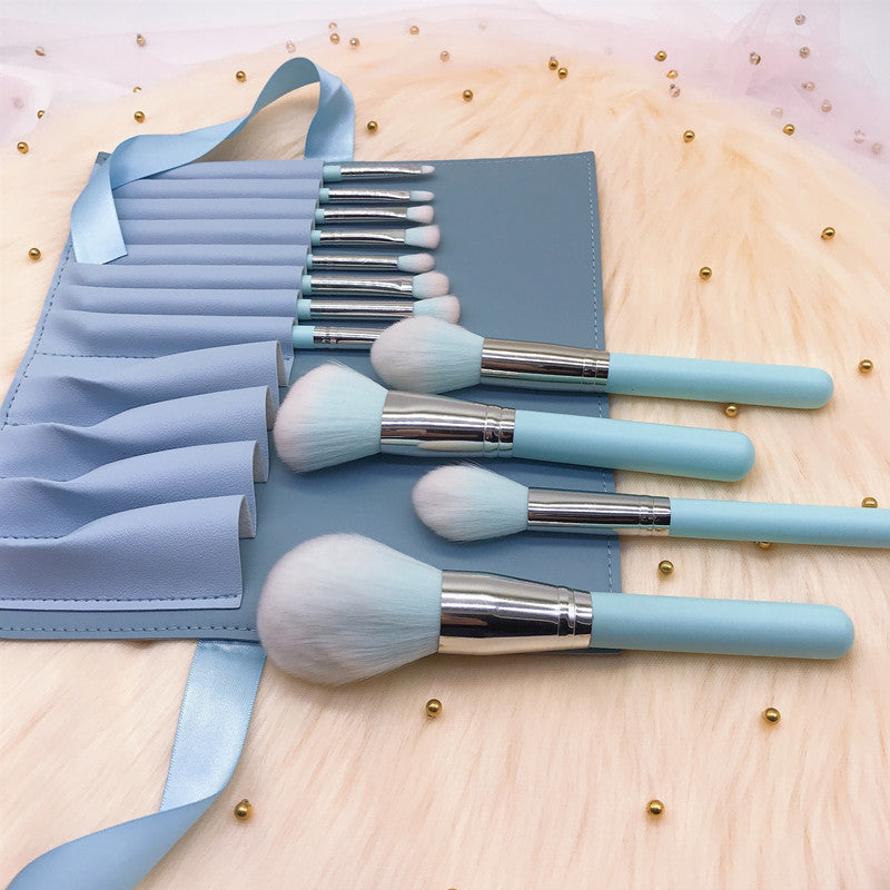 A set of 12 light blue wooden-handle makeup brushes, including small rainbow makeup brushes, powder brushes and eye brushes, as makeup tools.