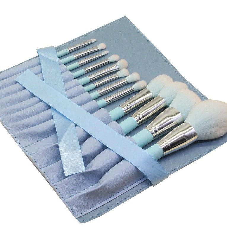 A set of 12 light blue wooden-handle makeup brushes, including small rainbow makeup brushes, powder brushes and eye brushes, as makeup tools.